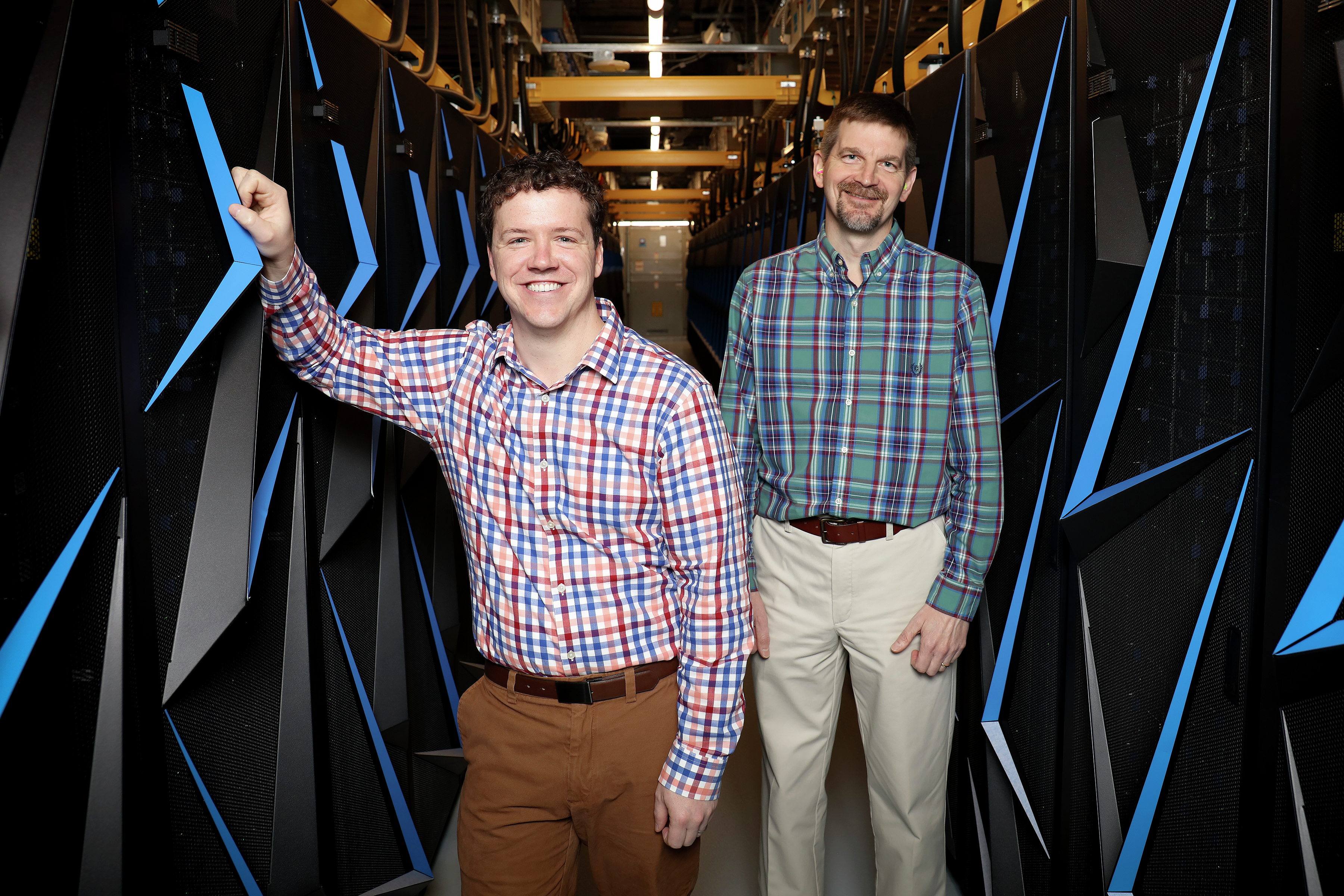 HPC systems administrator Matt Ezell (left) works alongside HPC systems team lead and Summit system owner Don Maxwell (right).