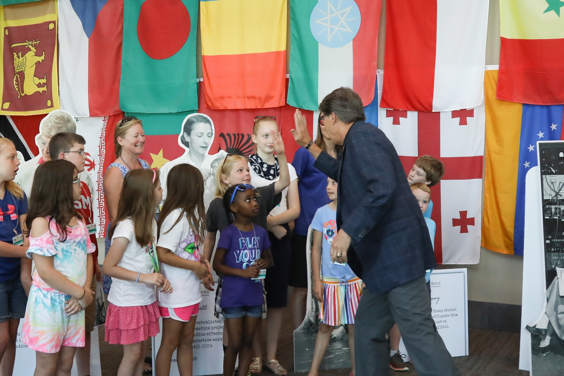 Secretary Perry high fives a group of children in the Court of Flags on June 8. Around 1,000 children and grandchildren of ORNL staff members attended Take Your Child to Work Day as part of ORNL’s 75th anniversary celebration weekend.