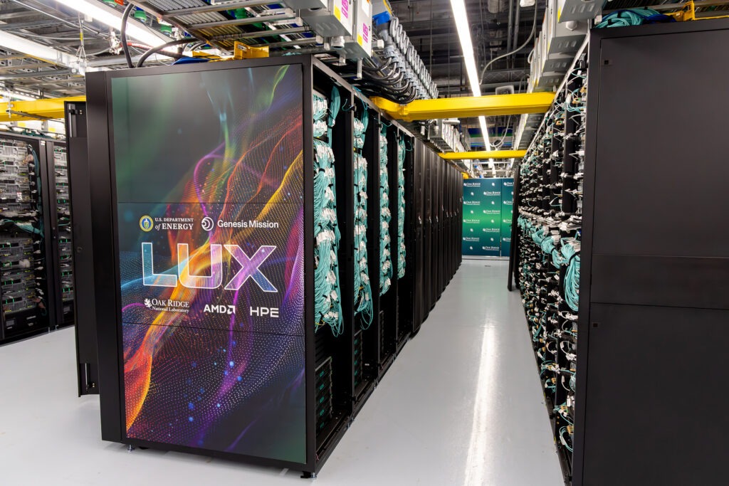 26_P000102 Views of the LUX computer system at Oak Ridge National Laboratory show server racks, networking cables, cooling infrastructure, safety signage, and installation work inside the high-performance computing data center on July 17, 2026.