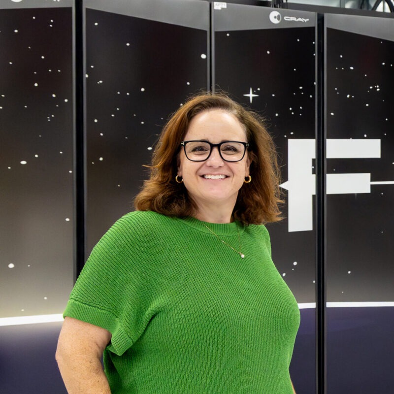 Katie Bethea, Group Leader for User Access, Outreach, and Communication, poses for a portrait in front of the Frontier supercomputer at Oak Ridge National Laboratory on July 17, 2026.