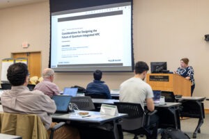 Laura Schulz delivers a presentation titled "Considerations for Designing the Future of Quantum-Integrated HPC" to attendees during the Open Quantum-HPC Software Ecosystem (openQSE) conference at Oak Ridge National Laboratory on July 24, 2026.