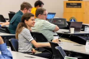 An attendee sits in the audience listening to Laura Schulz's presentation during the Open Quantum-HPC Software Ecosystem (openQSE) conference at Oak Ridge National Laboratory on July 24, 2026.